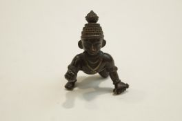 A 20th Century South East Asian bronze model of a boy drawing,