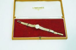 A lady's Longines 9 carat gold bracelet watch, with original case,