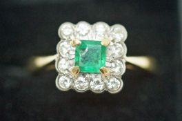 An emerald and diamond cluster ring, stamped '18ct',