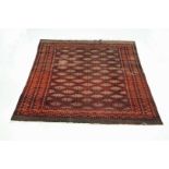 A red ground bokhara design rug with repeating girls within multiple borders 188 x 281 cm.