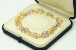 An amethyst beaded necklace and bracelet set, stamped '750',