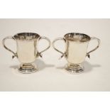 A pair of White metal two handled cups, in the 18th century style, 13.