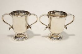 A pair of White metal two handled cups, in the 18th century style, 13.