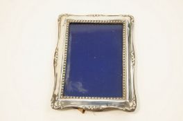 A silver photograph frame, by H.