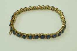 A sapphire and diamond line bracelet, indistinctly marked to the tongue of the clasp,
