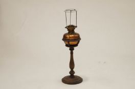 An early 20th Century brass lamp on a turned wooden pedestal base, 75cm high.