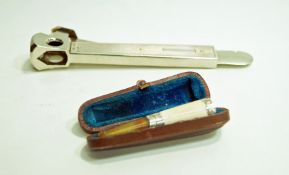 A silver cased and metal cigar cutter;