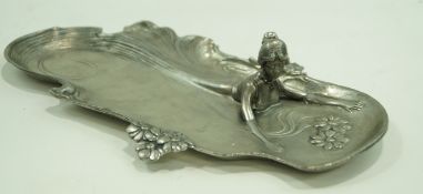 A French Art Nouveau style pewter tray in the form of a lady swimming, stamped Etain,