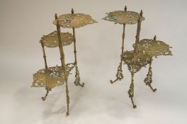 A pair of brass 3 tier plant stands, each tier pierced and decorated with butterflies 77cm high.
