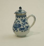 An 18th Century Chinese baluster mug and cover decorated with flowers and plants, 12cms high.