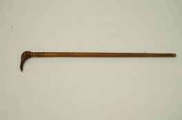 An interesting 20th Century walking stick, the handle carved in the form of a bird,