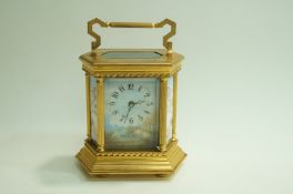 A 20th Century brass French carriage clock, with painted enamel pane of Cherubs,