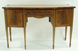 A 19th Century mahogany crossbanded bow fronted sideboard with two cupboard doors flanking a frieze
