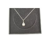 A 9 carat gold and cultured pearl pendant on a chain, the pearl of approximately 6 mm diameter,