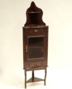 An Edwardian small standing corner cabinet on open stand,