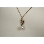 A 9 carat gold amethyst and cultured pearl pendant on a chain,