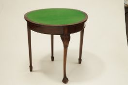 A Victorian mahogany fold over card table with an extending single leg,
