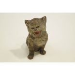A ceramic model of a seated cat, in the style of 'Louis Wain' , suffragette interest,