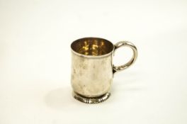 A silver mug with a scroll handle and a reeded band, London 1957 by Garrard & Co Ltd,