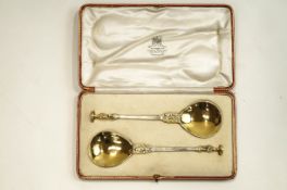 A pair of silver parcel gilt apostle serving spoons, London 1911 by William Hutton & Sons Ltd,
