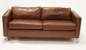 A modern two seater leather sofa, 62cm high x 178cm long x 89cm wide.