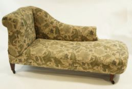 A mid 20th Century day bed with drop down post, on mahogany legs, upholstered in a floral fabric,