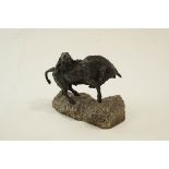 A bronze sculpture of a lioness attacking a bull on a rough cut marble stand, signed FACOTO.