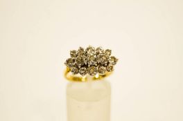 A fifteen stone diamond 18 carat gold cluster ring, the brilliant cuts set across the finger,