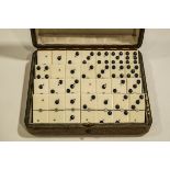 A set of twenty eight Ivory and ebony Dominoes, set within a leather covered box, stamped A.B.