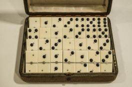 A set of twenty eight Ivory and ebony Dominoes, set within a leather covered box, stamped A.B.