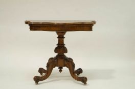 A Victorian walnut card table the shaped fold over top on carved balustrade support on four splayed