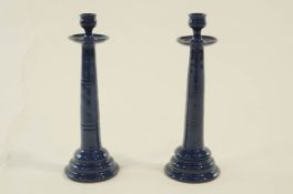 A pair of Brannam pottery candlesticks with circular ribbed stepped base and drip trays.
