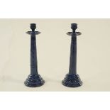 A pair of Brannam pottery candlesticks with circular ribbed stepped base and drip trays.