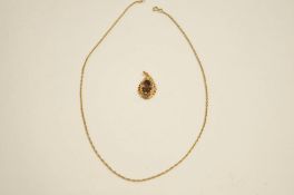 A smoky quartz pendant on a 9 carat gold mount, on a chain, 6.