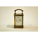 A 20th Century French brass carriage clock, enamelled with Roman numerals,