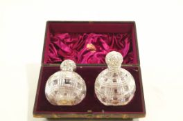 A pair of silver scent topped bottles