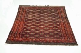 A red ground bokhara design rug with repeating girls within multiple borders 188 x 281 cm.