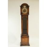 A mid 20th Century oak long case clock with brass dials and Roman numerals,