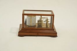 A barograph by F Darton & Co in a mahogany glazed case with base drawer 39cm wide