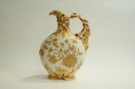 A late 19th Century porcelain continental ewer, decorated with gilded flowers,