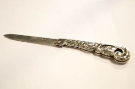 An unusual Victorian silver fruit knife, the handle chased with scrolls,