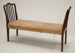 An Edwardian mahogany window bench with shaped and slated ends,
