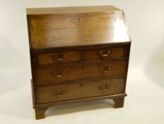 A George III mahogany slope front bureau with fitted interior over 4 drawers,