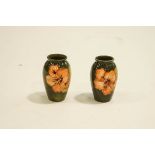 A pair of Moorcroft Hibiscus pattern vases, of baluster form.