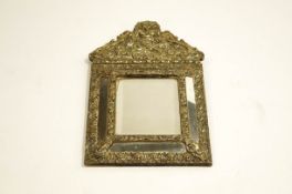 A 19th Century brass wall mirror with bevelled plate and cushion frame,