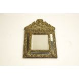 A 19th Century brass wall mirror with bevelled plate and cushion frame,