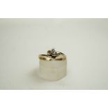 A diamond three stone cross-over ring,