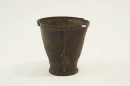 A late 18th/early 19th Century leather bucket with riveted brass rim, some cracking but intact,
