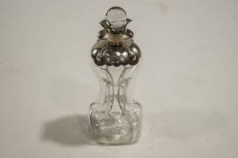 A silver mounted 'glug-glug' decanter with clear glass stopper, London 1898, 30cms high,