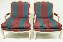 A pair of French style armchairs with limed frames and cabriole legs.